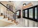 Bright foyer featuring marble floors, an elegant staircase, and a view of the formal living spaces at 1681 Long Bow Ln, Clearwater, FL 33764