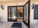 Elegant front door with decorative glass panels and modern lighting, offering a peek into the inviting foyer at 1681 Long Bow Ln, Clearwater, FL 33764