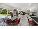 Eat-in kitchen features white cabinetry, stainless appliances, and a center island with black countertops at 1681 Long Bow Ln, Clearwater, FL 33764