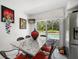 Eat-in kitchen featuring stainless steel refrigerator, sliding doors to the pool, and granite countertops at 1681 Long Bow Ln, Clearwater, FL 33764