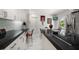 Modern eat-in kitchen with stainless appliances, black countertops, and access to the backyard and pool at 1681 Long Bow Ln, Clearwater, FL 33764