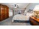 A relaxing main bedroom featuring a ceiling fan and a decorative headboard at 1681 Long Bow Ln, Clearwater, FL 33764