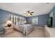 Comfortable bedroom with soft lighting, fan, and light-blue walls for relaxation at 1681 Long Bow Ln, Clearwater, FL 33764