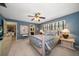 Spacious bedroom features soft colors, natural light, and an ensuite bathroom at 1681 Long Bow Ln, Clearwater, FL 33764