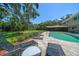 A serene pool area with lounge chairs offers an inviting outdoor space for relaxation and leisure at 1681 Long Bow Ln, Clearwater, FL 33764