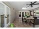 Bright screened patio with tile floor, ceiling fan, and view of backyard, perfect for enjoying outdoor living at 1681 Long Bow Ln, Clearwater, FL 33764