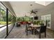 The screened patio has ample space, perfect for entertaining, complete with outdoor seating and tranquil backyard views at 1681 Long Bow Ln, Clearwater, FL 33764