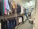 Large, walk-in closet with ample hanging space and built-in shelving at 1681 Long Bow Ln, Clearwater, FL 33764