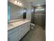 Modern bathroom featuring a double sink vanity with a glass-enclosed shower and neutral colors at 18848 Indian Rock Pl, Lakewood Ranch, FL 34211