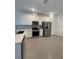 Modern kitchen featuring stainless steel appliances, and white cabinetry with stone countertops at 18848 Indian Rock Pl, Lakewood Ranch, FL 34211