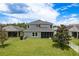 Expansive backyard featuring lush green grass and a screened patio at 19309 Prairie Tree Pl, Tampa, FL 33647