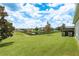 Spacious backyard overlooking a serene pond, with neighborhood homes in the distance at 19309 Prairie Tree Pl, Tampa, FL 33647