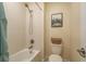 Bathroom featuring a tiled tub and shower combination, plus linen closet, and toilet at 19309 Prairie Tree Pl, Tampa, FL 33647