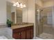 Well-lit bathroom with a glass-enclosed shower, and a granite-topped vanity with modern fixtures at 19309 Prairie Tree Pl, Tampa, FL 33647