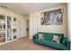 Bonus room featuring a green sofa, decorative pillows, and a large art piece and modern shelving at 19309 Prairie Tree Pl, Tampa, FL 33647
