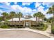 Exterior of community clubhouse featuring landscaping, playground and gated entrance at 19309 Prairie Tree Pl, Tampa, FL 33647