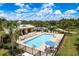 Community pool with lounge chairs, tables, and umbrellas at 19309 Prairie Tree Pl, Tampa, FL 33647