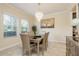 Elegant dining room featuring a chandelier, a table with upholstered chairs, and large windows at 19309 Prairie Tree Pl, Tampa, FL 33647