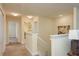 Upstairs hallway with neutral carpet, closet, and a laundry room at 19309 Prairie Tree Pl, Tampa, FL 33647