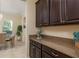 Kitchen countertop featuring dark cabinetry, granite countertops, and stainless appliances at 19309 Prairie Tree Pl, Tampa, FL 33647
