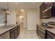 Well-equipped kitchen featuring granite countertops, stainless steel appliances, and tile flooring at 19309 Prairie Tree Pl, Tampa, FL 33647