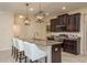 Beautiful kitchen with a center island, dark cabinets, and modern appliances and fixtures at 19309 Prairie Tree Pl, Tampa, FL 33647