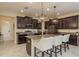 Modern kitchen featuring dark cabinets, a center island with seating, and stainless steel appliances at 19309 Prairie Tree Pl, Tampa, FL 33647