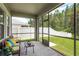 Cozy screened lanai with outdoor seating and view of the landscaped backyard at 19309 Prairie Tree Pl, Tampa, FL 33647