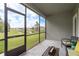 Relaxing screened lanai with views of a peaceful pond and manicured backyard at 19309 Prairie Tree Pl, Tampa, FL 33647