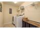 Well-equipped laundry room with washer, dryer, storage, and motivational wall art at 19309 Prairie Tree Pl, Tampa, FL 33647