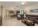 Spacious open-plan living room features tile floors, dining area, and a modern, well-equipped kitchen at 19309 Prairie Tree Pl, Tampa, FL 33647