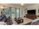 Comfortable living room with tile floors, plush seating, and large windows offering outdoor views at 19309 Prairie Tree Pl, Tampa, FL 33647