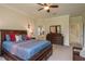 Spacious main bedroom features a dresser, ensuite bathroom, and natural light from large windows at 19309 Prairie Tree Pl, Tampa, FL 33647