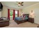 Cozy main bedroom with a comfortable bed, soft carpet, and a view of the outdoors at 19309 Prairie Tree Pl, Tampa, FL 33647