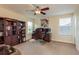 Home office showcasing a desk with computer setup, a leather chair, and wooden bookshelves at 19309 Prairie Tree Pl, Tampa, FL 33647
