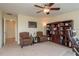 Office featuring two patterned chairs with a glass coffee table and built-in wooden bookshelves at 19309 Prairie Tree Pl, Tampa, FL 33647