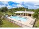 Beautiful community pool with lounge chairs and covered area for relaxing and socializing at 19309 Prairie Tree Pl, Tampa, FL 33647