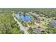 Great view of a well landscaped home by the water with a screened-in pool and lush surrounding greenery at 2202 Hickory Ridge Dr, Valrico, FL 33596