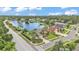 Beautiful aerial view of a suburban home next to a lake with well-maintained landscaping and surrounding greenery at 2202 Hickory Ridge Dr, Valrico, FL 33596