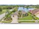Aerial shot of a landscaped house with an attached two car garage and lake views at 2202 Hickory Ridge Dr, Valrico, FL 33596