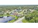 Suburban street view with a home that has a screened-in pool, lawn and surrounding neighborhood and trees at 2202 Hickory Ridge Dr, Valrico, FL 33596