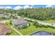 An elevated view shows a screened-in pool and lanai area with landscaping and a sprawling green lawn at 2202 Hickory Ridge Dr, Valrico, FL 33596