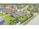 Aerial shot of a large backyard with a screened-in pool, lush lawn, and neat landscaping near a pond at 2202 Hickory Ridge Dr, Valrico, FL 33596