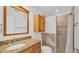 Bathroom featuring a granite vanity, tiled shower, and built-in storage for a clean and modern look at 2202 Hickory Ridge Dr, Valrico, FL 33596