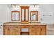 Bathroom featuring double sinks, granite countertops, and framed mirrors at 2202 Hickory Ridge Dr, Valrico, FL 33596