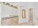 Bathroom featuring tiled wainscoting, and view of walk-in closet at 2202 Hickory Ridge Dr, Valrico, FL 33596