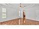 Bright bedroom with wood floors, tray ceiling, and ensuite bath at 2202 Hickory Ridge Dr, Valrico, FL 33596