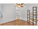 Light and airy bedroom featuring hardwood floors, ceiling fan, and contemporary decor at 2202 Hickory Ridge Dr, Valrico, FL 33596