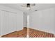 Bright bedroom with wood-look floors, white trim and double door closet at 2202 Hickory Ridge Dr, Valrico, FL 33596