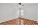 Well-lit bedroom features laminate wood floors and a ceiling fan, creating a cozy space at 2202 Hickory Ridge Dr, Valrico, FL 33596